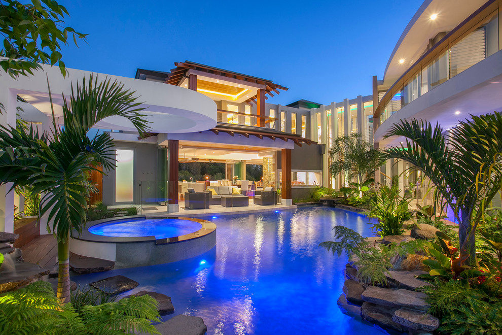Inspiration for a large tropical custom-shaped pool in Sunshine Coast with a hot tub.