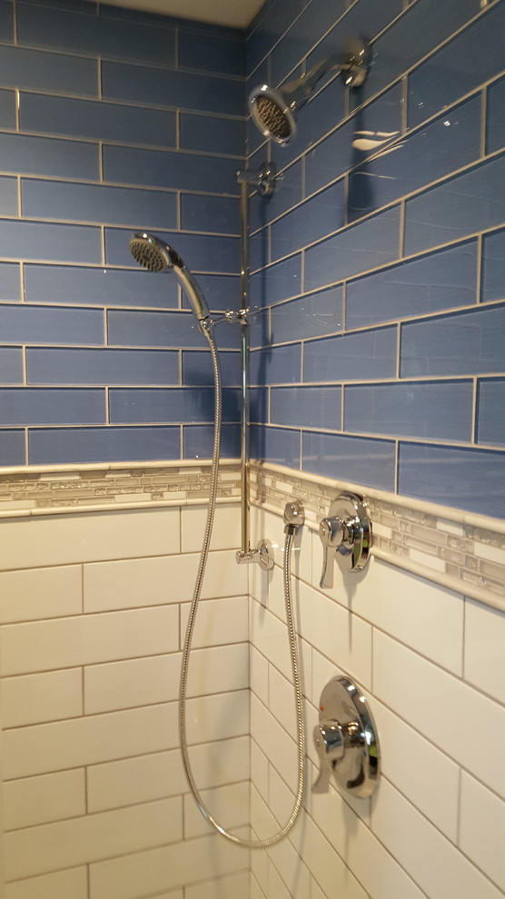Example of a small transitional 3/4 blue tile and glass tile porcelain tile alcove shower design in Cincinnati with recessed-panel cabinets, black cabinets, a two-piece toilet, gray walls, an undermount sink and quartz countertops