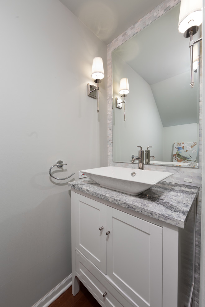 Photo of a mid-sized contemporary master bathroom in Chicago with flat-panel cabinets, medium wood cabinets, a drop-in tub, an alcove shower, a one-piece toilet, beige walls, cement tiles, an undermount sink, limestone benchtops, gray tile and travertine.