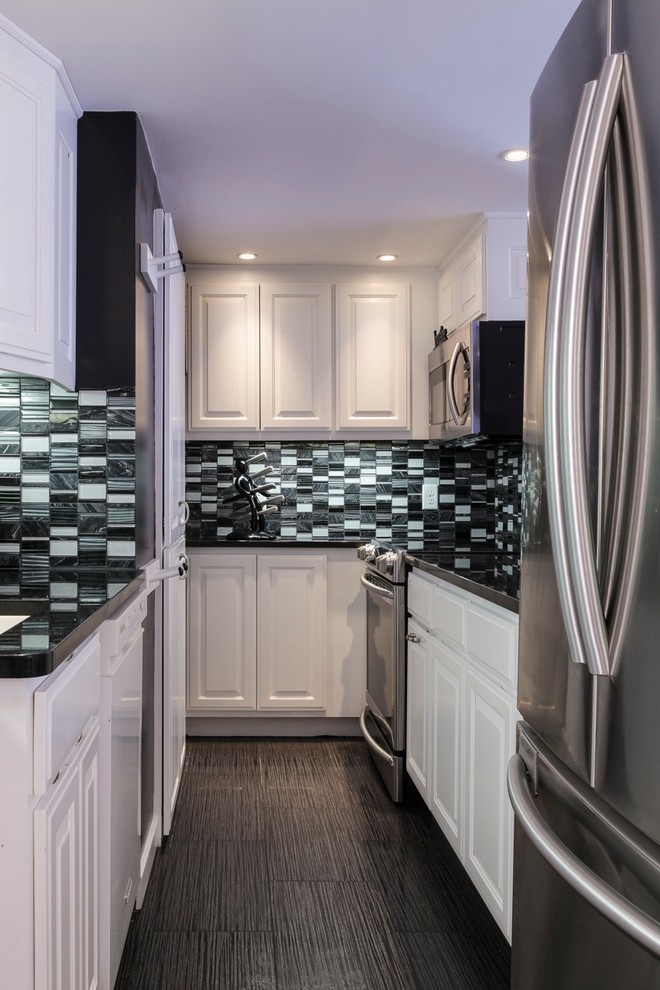 Inspiration for a small transitional galley porcelain tile and brown floor enclosed kitchen remodel in Baltimore with raised-panel cabinets, white cabinets, quartz countertops, green backsplash, stone tile backsplash and stainless steel appliances