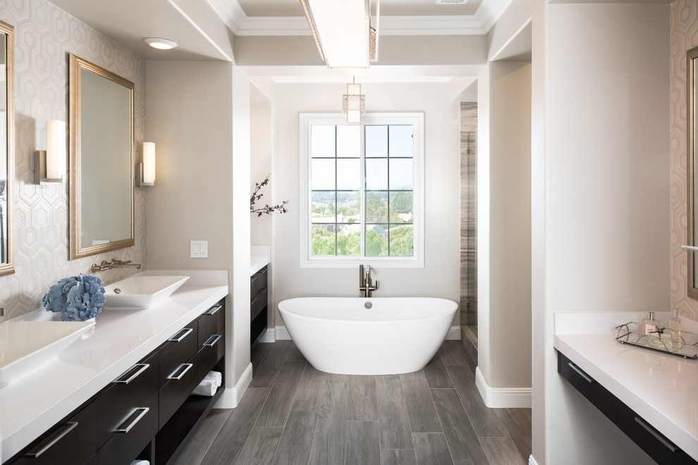 Freestanding bathtub - transitional gray tile freestanding bathtub idea in Orange County with flat-panel cabinets and black cabinets