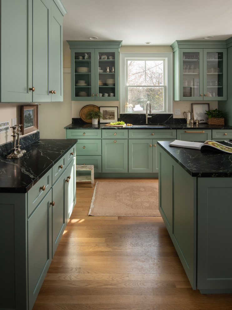 Photo of a mid-sized traditional galley separate kitchen in Boston with a single-bowl sink, shaker cabinets, green cabinets, soapstone benchtops, beige splashback, stainless steel appliances, medium hardwood floors, with island, brown floor and green benchtop.