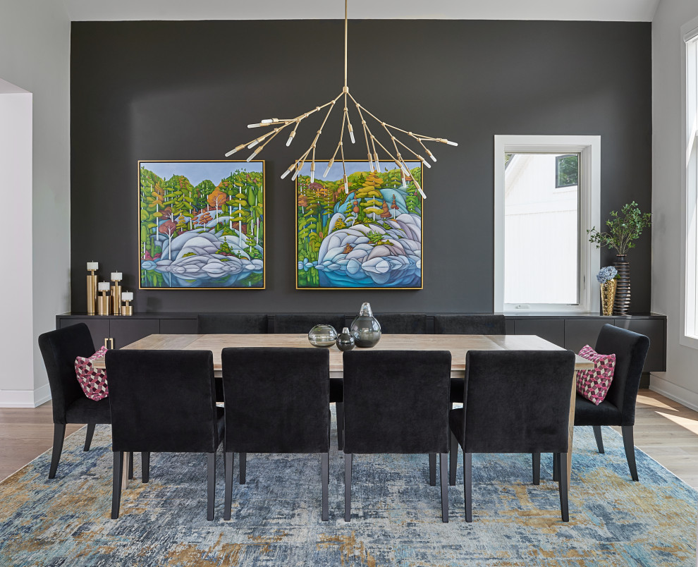 Contemporary dining room in Toronto with black walls, medium hardwood floors and brown floor.