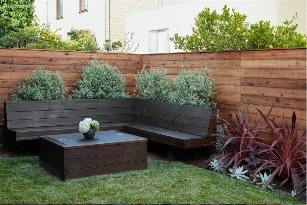 This is an example of a mid-sized modern backyard patio in San Francisco with a fire feature, tile and no cover.