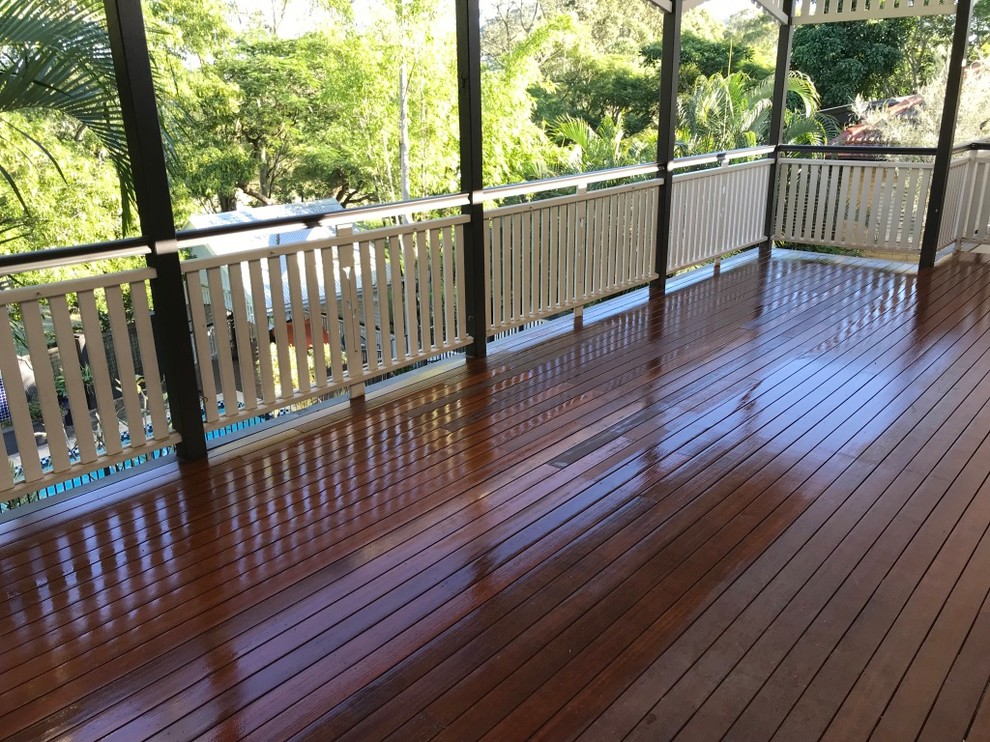Mid-sized traditional backyard deck in Brisbane with a roof extension.