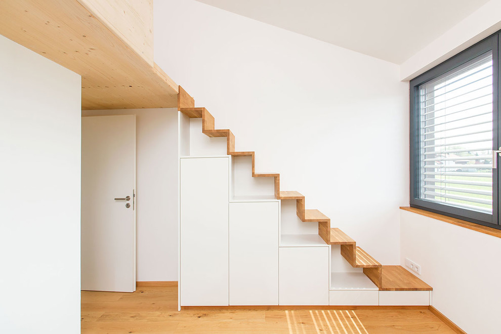 Photo of a small wood straight staircase in Other with wood risers.