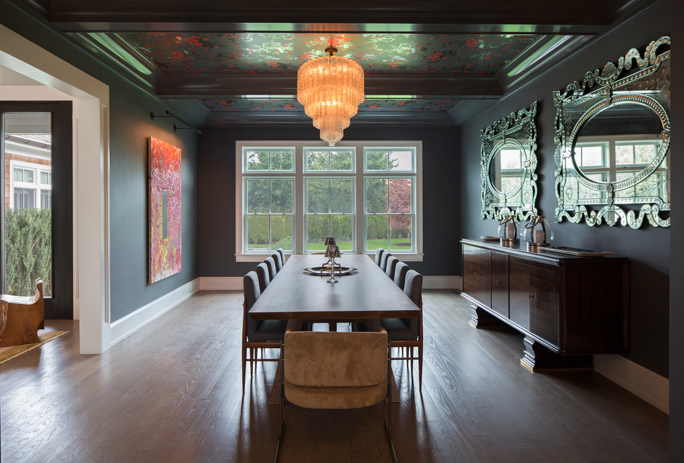Large transitional separate dining room in New York with black walls, dark hardwood floors and no fireplace.