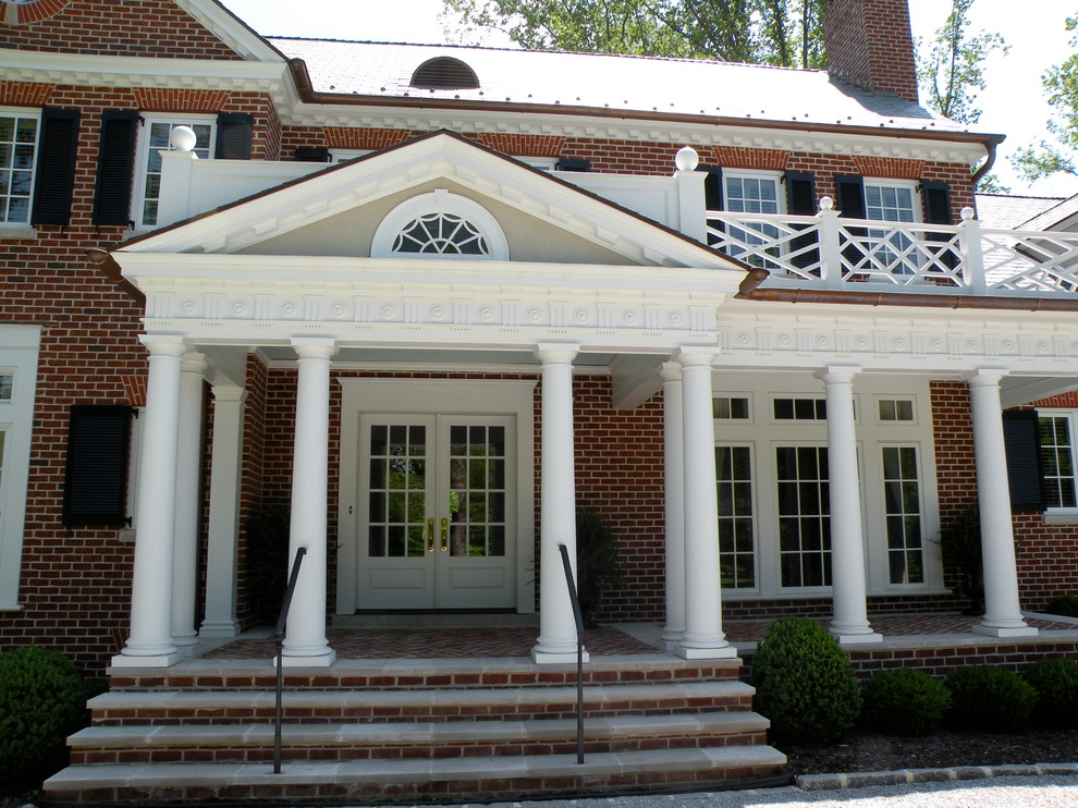 Photo of a large traditional two-storey brick white exterior in Louisville.