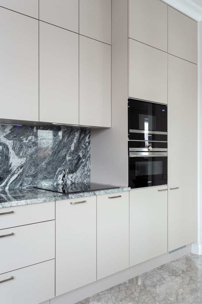 Photo of a mid-sized modern single-wall eat-in kitchen in Moscow with an undermount sink, flat-panel cabinets, beige cabinets, quartz benchtops, grey splashback, stone slab splashback, black appliances, marble floors, no island, grey floor and grey benchtop.