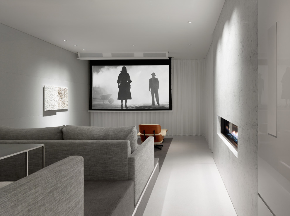 Inspiration for a large contemporary enclosed home theatre in Los Angeles with grey walls, a projector screen and grey floor.