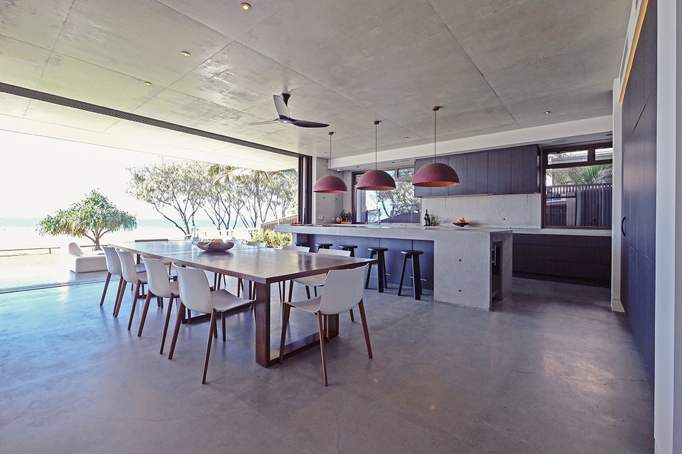 This is an example of a mid-sized contemporary open plan dining in Brisbane with concrete floors, no fireplace and grey floor.