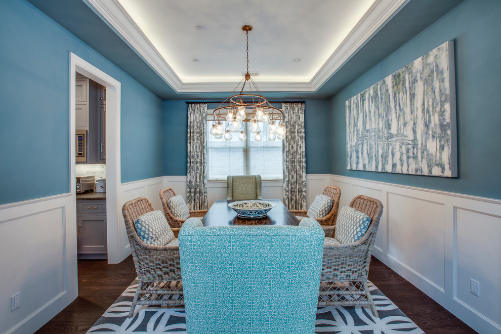 Inspiration for a beach style separate dining room in Los Angeles with blue walls and dark hardwood floors.