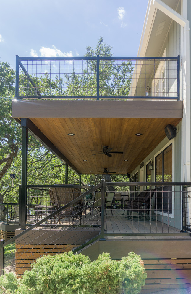 Deck - large rustic backyard balcony deck idea in Austin
