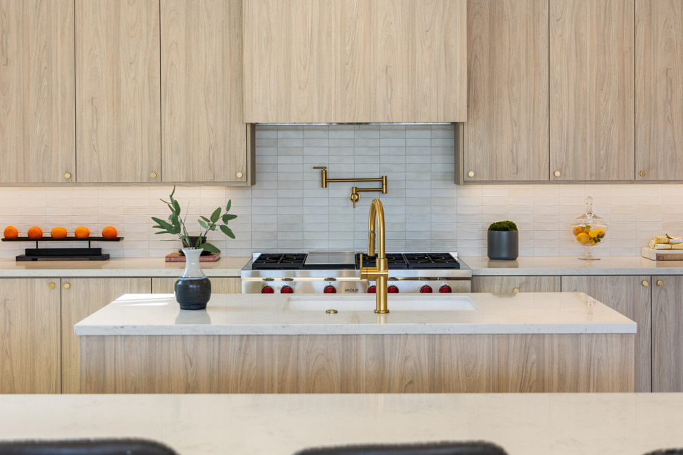 Mid-sized transitional u-shaped porcelain tile and beige floor enclosed kitchen photo with an undermount sink, flat-panel cabinets, medium tone wood cabinets, quartz countertops, white backsplash, ceramic backsplash, stainless steel appliances, two islands and white countertops