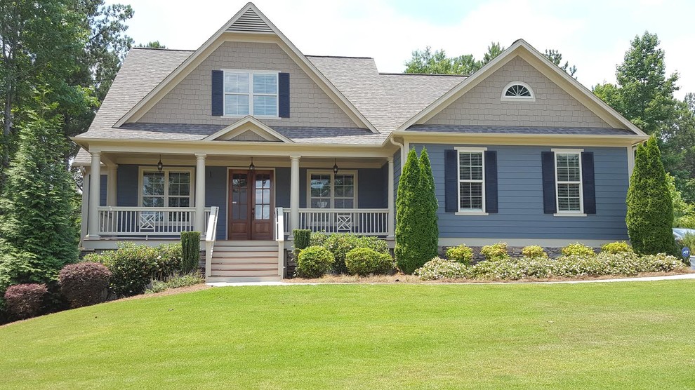 This is an example of a large traditional two-storey blue exterior in Atlanta with mixed siding and a gable roof.