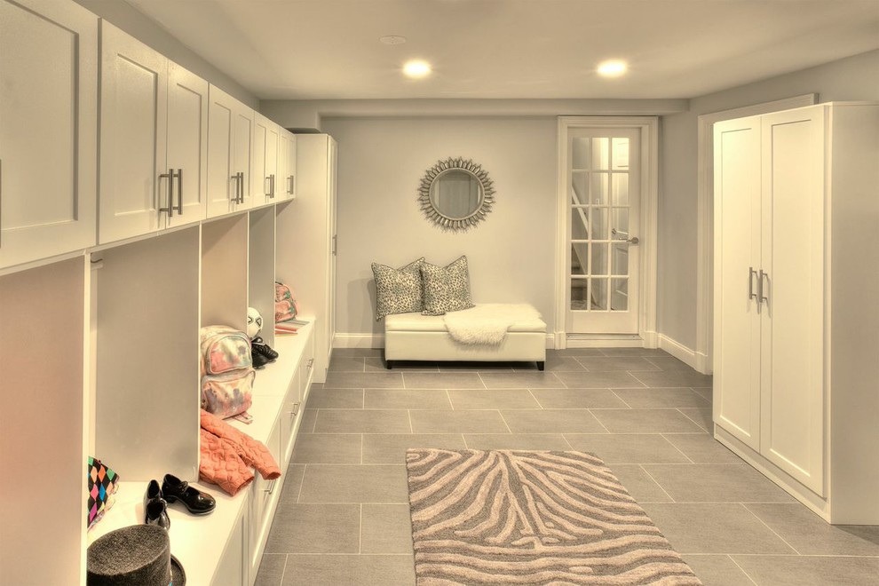 Large contemporary entryway in New York with porcelain floors.