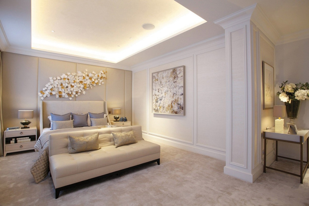 Inspiration for a large traditional master bedroom in London with beige walls, carpet, no fireplace, beige floor, recessed and decorative wall panelling.