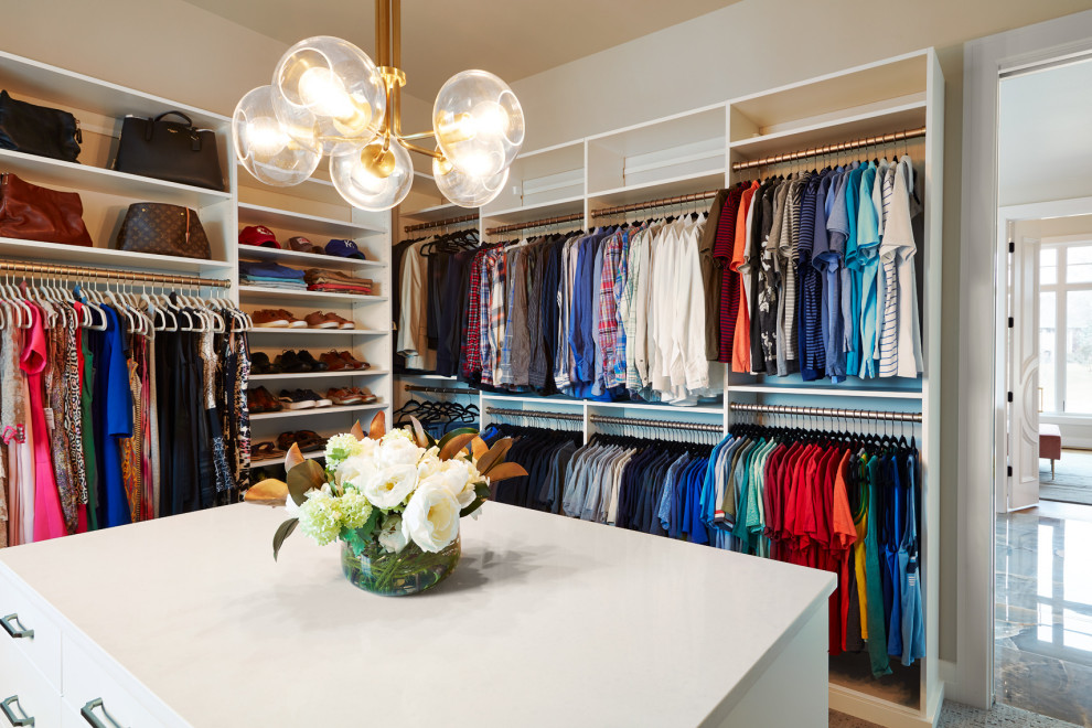 Inspiration for a large transitional gender-neutral walk-in closet remodel with white cabinets