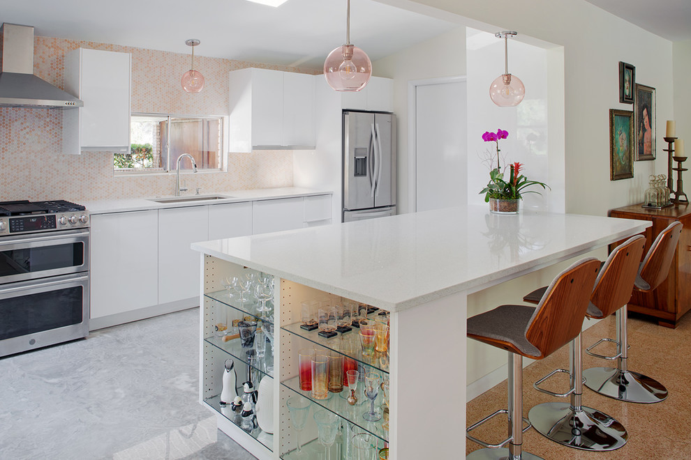 Inspiration for a mid-sized midcentury l-shaped eat-in kitchen in Other with an undermount sink, flat-panel cabinets, white cabinets, quartz benchtops, multi-coloured splashback, ceramic splashback, stainless steel appliances, concrete floors, with island, grey floor and white benchtop.