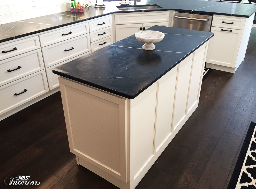 Inspiration for a mid-sized transitional u-shaped dark wood floor and brown floor eat-in kitchen remodel with an undermount sink, recessed-panel cabinets, white cabinets, soapstone countertops, white backsplash, subway tile backsplash, stainless steel appliances and an island
