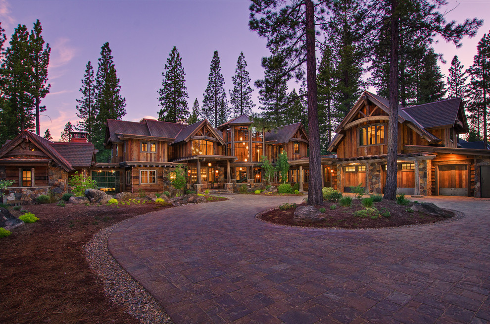 This is an example of an expansive country two-storey exterior in Sacramento with wood siding.