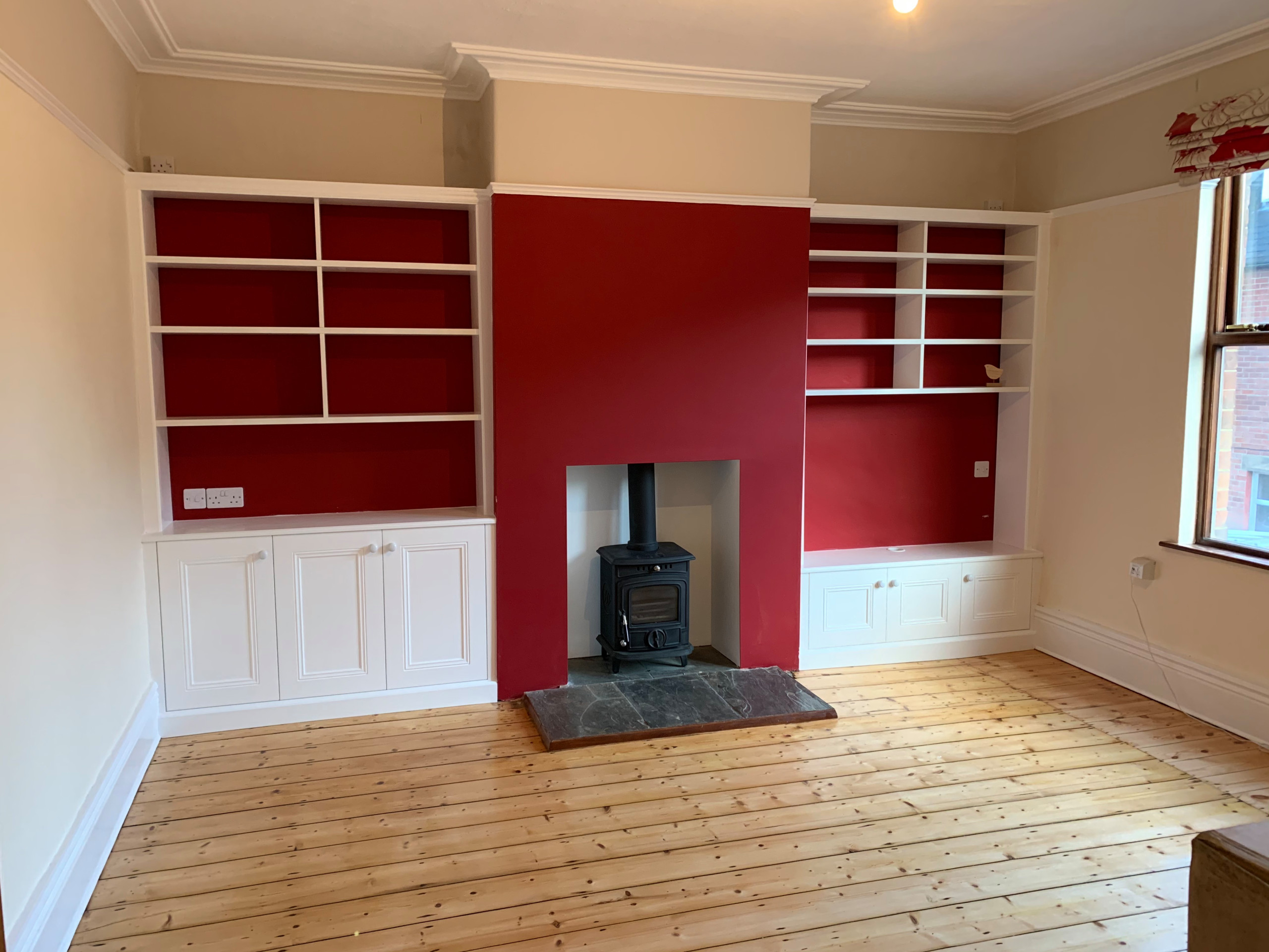 Classic Alcoves with Backless Bookcases Against a Red Wall