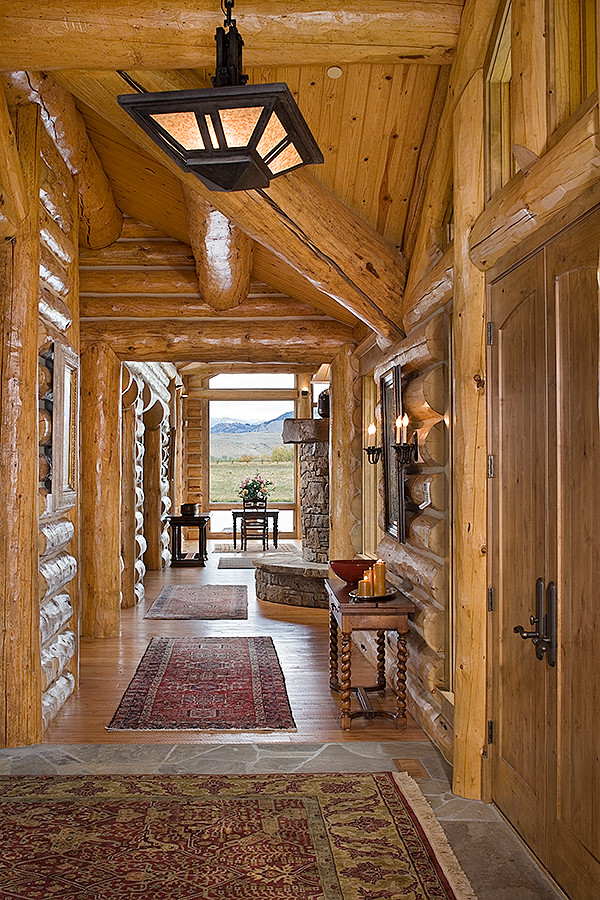 Photo of a country entry hall in Other with medium hardwood floors, a double front door and a medium wood front door.