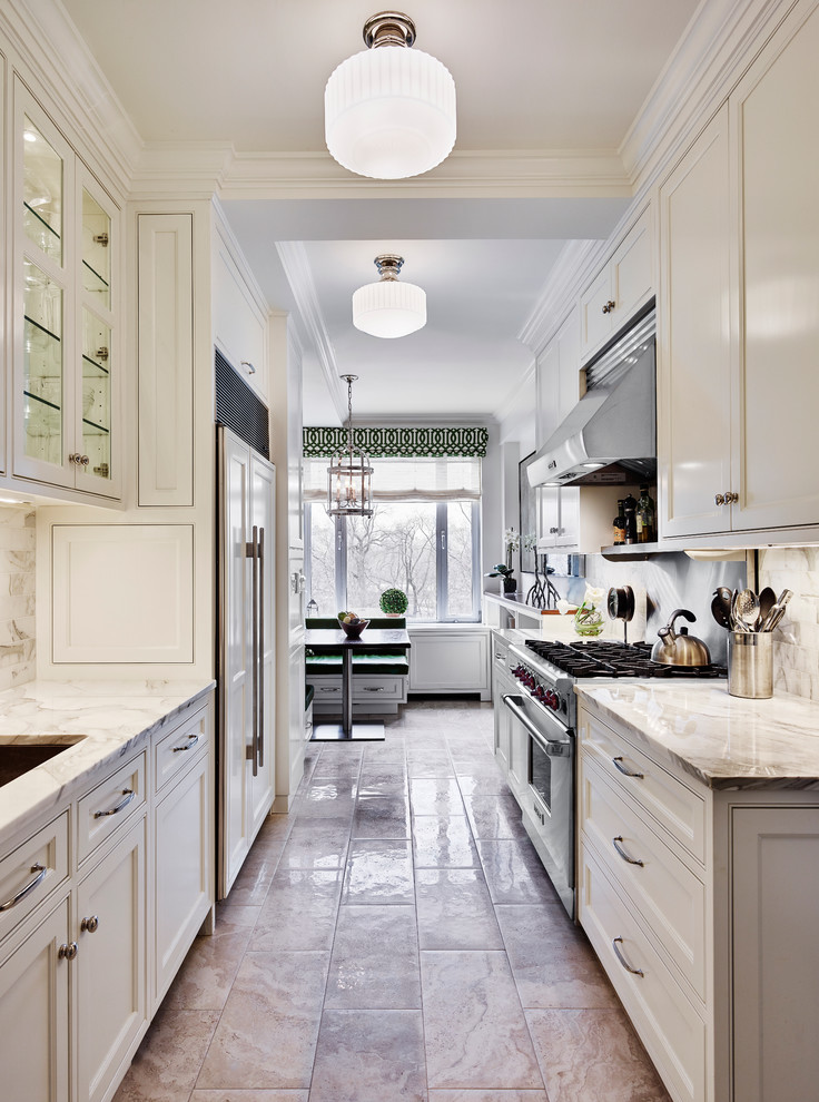 Inspiration for a traditional galley eat-in kitchen in New York with an undermount sink, beaded inset cabinets, white cabinets, white splashback, stainless steel appliances and no island.