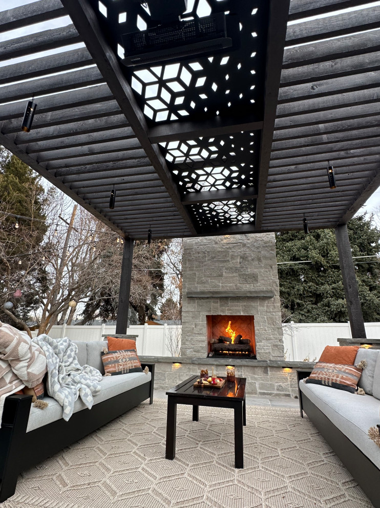 Design ideas for a large modern back patio in Denver with a fireplace, tiled flooring and a pergola.