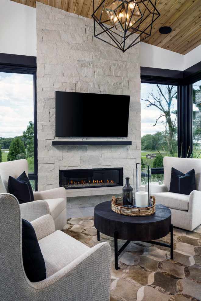 Inspiration for a contemporary games room in Minneapolis with a home bar, a standard fireplace and a stone fireplace surround.