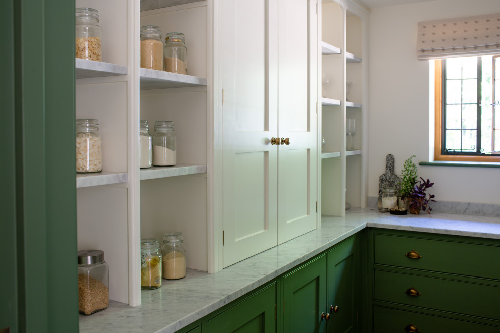 This is an example of a small classic u-shaped kitchen pantry in Surrey with beaded cabinets, green cabinets, marble worktops, grey splashback, brick flooring, red floors and grey worktops.