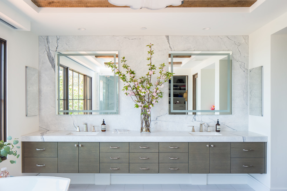 Inspiration for an expansive mediterranean master bathroom in Orange County with flat-panel cabinets, grey cabinets, blue tile, white walls, an undermount sink, a hinged shower door, white benchtops, a freestanding tub and a corner shower.