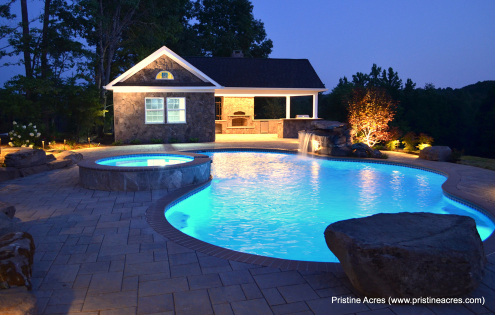 Huge transitional backyard concrete paver and custom-shaped natural pool fountain photo in DC Metro