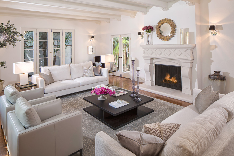 Traditional formal living room in Los Angeles with white walls and dark hardwood floors.