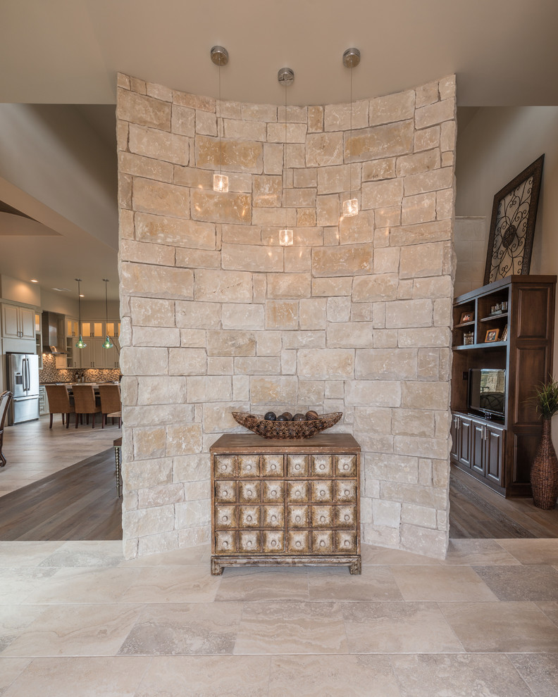 Transitional hallway in Austin with white walls and travertine floors.