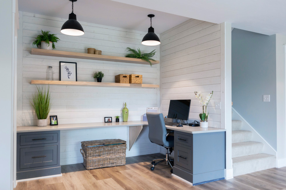 Photo of a transitional home office in Grand Rapids with white walls.