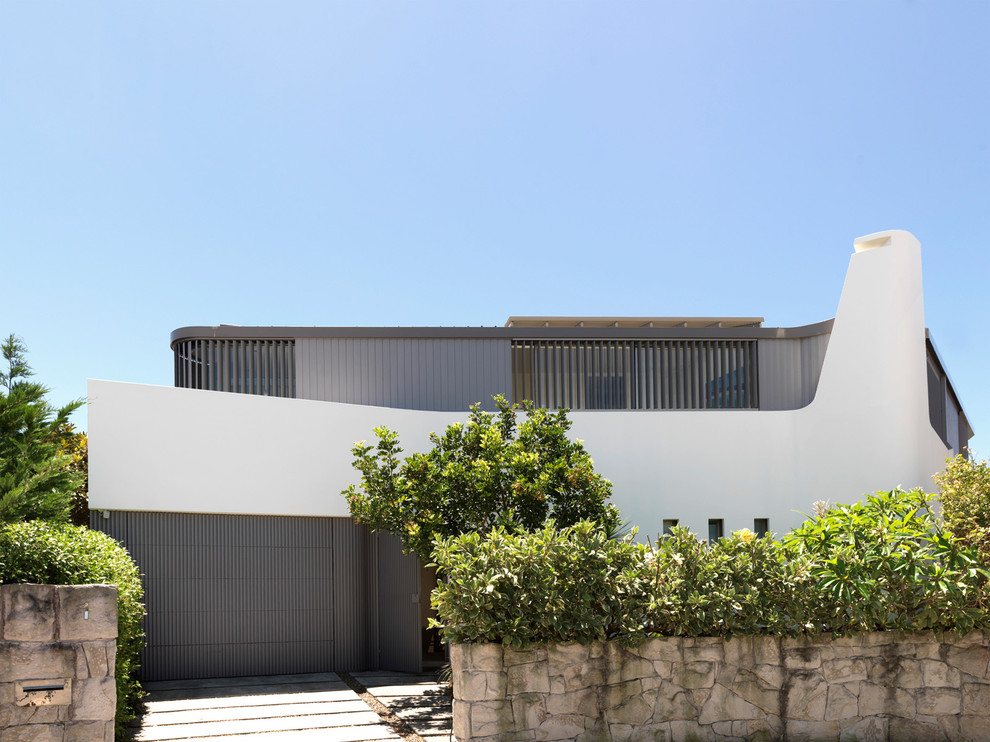 Inspiration for a contemporary two-storey exterior in Sydney with a flat roof.