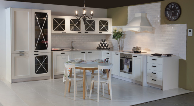 This is an example of a large country l-shaped open plan kitchen in Other with a drop-in sink, beaded inset cabinets, light wood cabinets, marble benchtops, white splashback, porcelain splashback, panelled appliances and marble floors.
