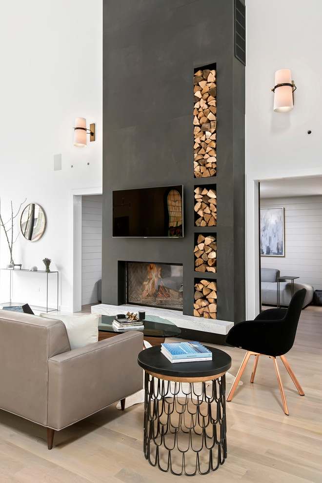 Contemporary open concept living room in Chicago with white walls, light hardwood floors, a standard fireplace and a wall-mounted tv.