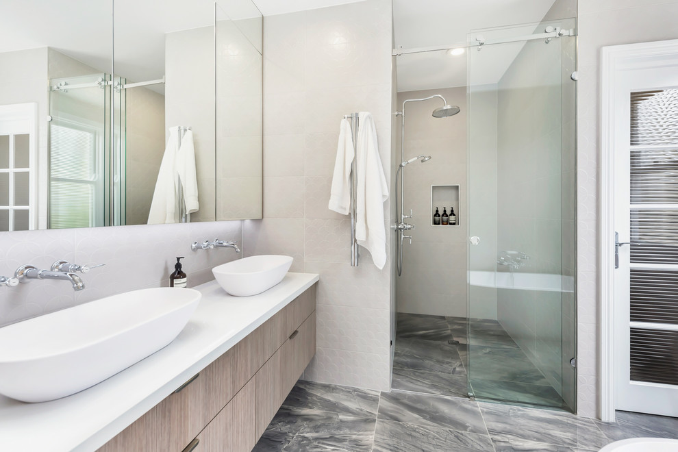 Contemporary master bathroom in Brisbane with flat-panel cabinets, beige cabinets, beige walls, a vessel sink, grey floor, a sliding shower screen and white benchtops.