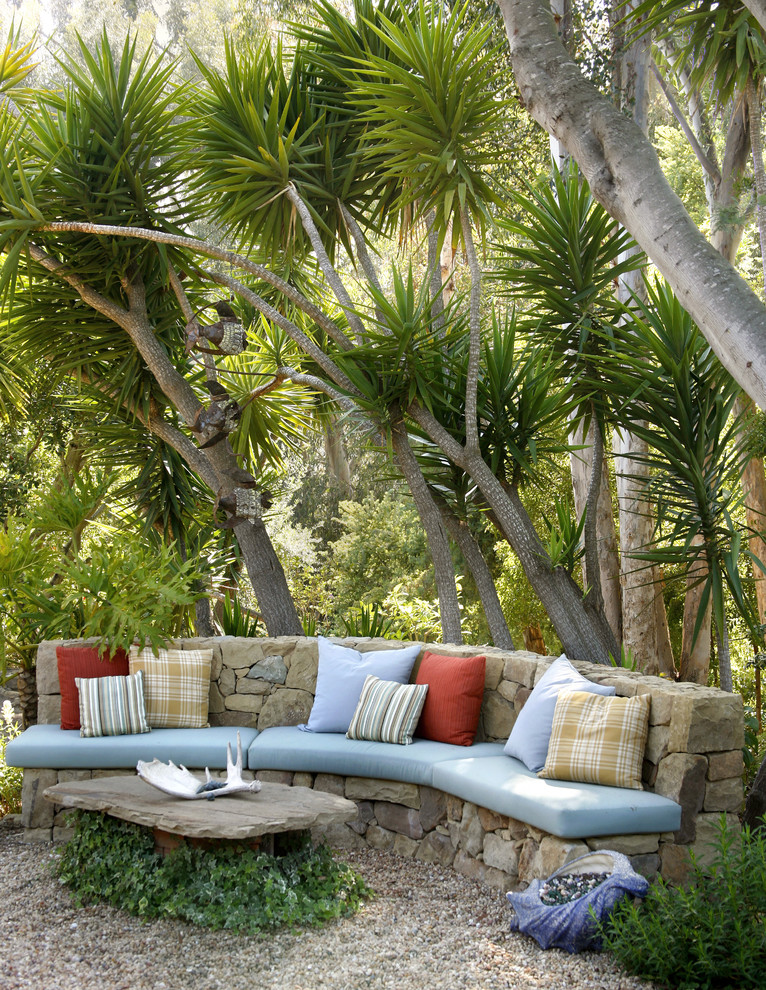 Mid-sized tropical backyard partial sun garden in Santa Barbara with gravel.