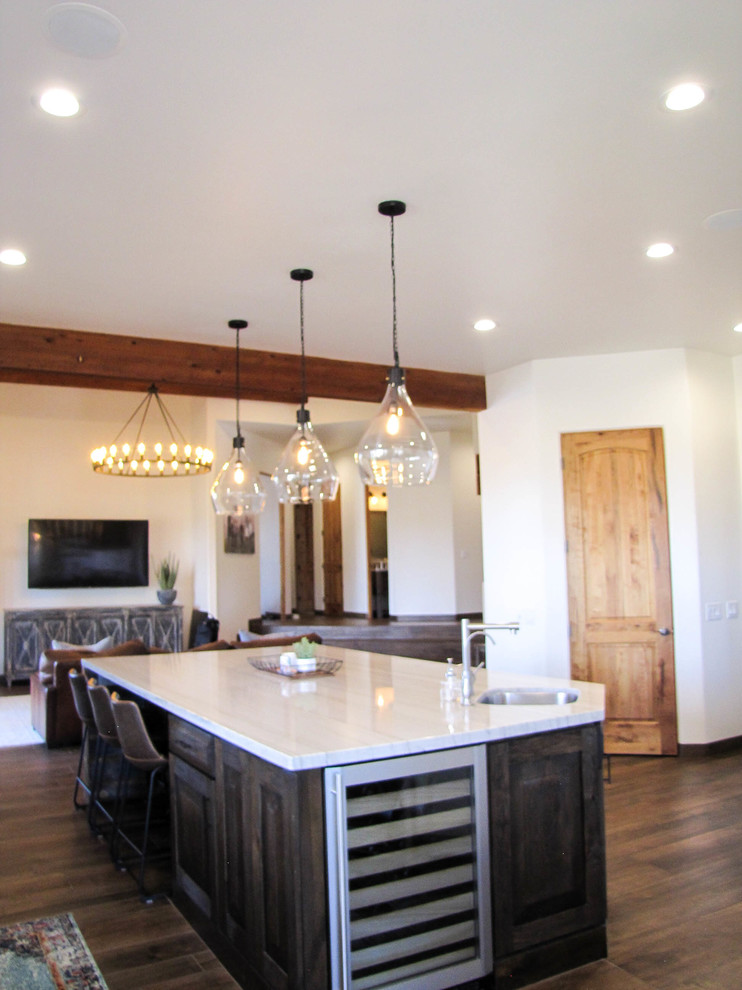 Large transitional porcelain tile and brown floor kitchen photo in Phoenix with white backsplash, subway tile backsplash, stainless steel appliances and an island