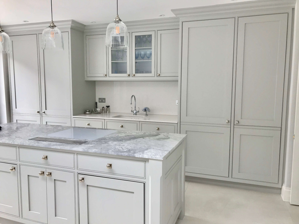 Mid-sized contemporary galley eat-in kitchen in London with a drop-in sink, shaker cabinets, green cabinets, marble benchtops, white splashback, limestone splashback, white appliances, cement tiles, with island, white floor, grey benchtop and coffered.