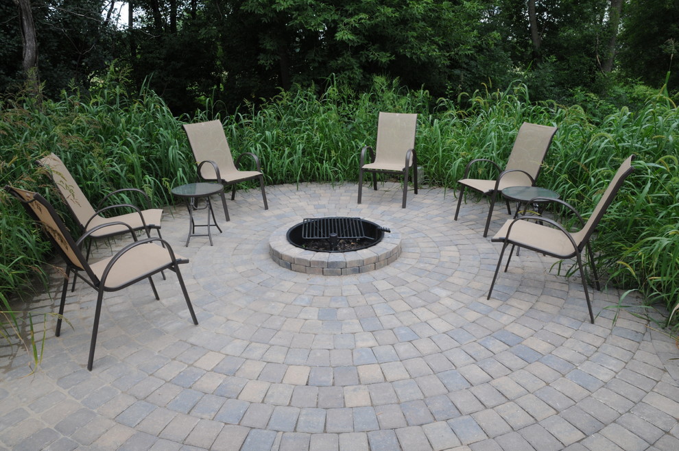 Photo of a small traditional backyard patio in Minneapolis with a fire feature, concrete pavers and no cover.