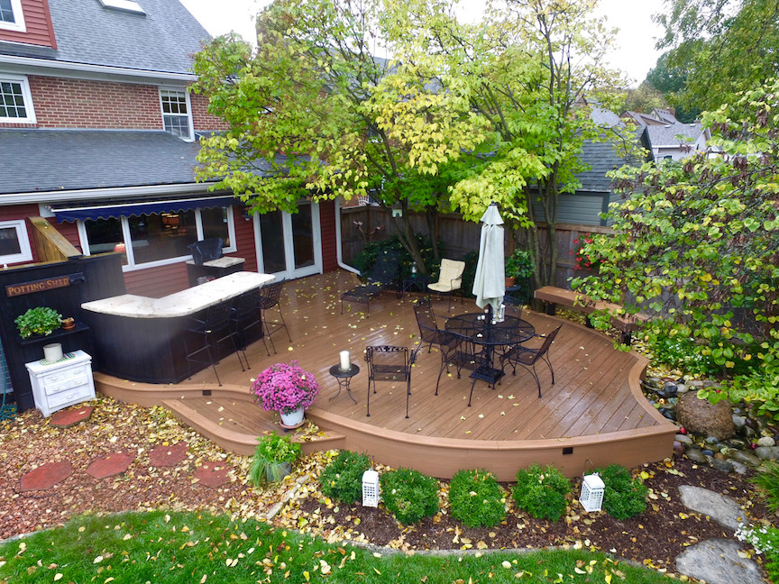 Mid-sized contemporary backyard deck in Other with a water feature.