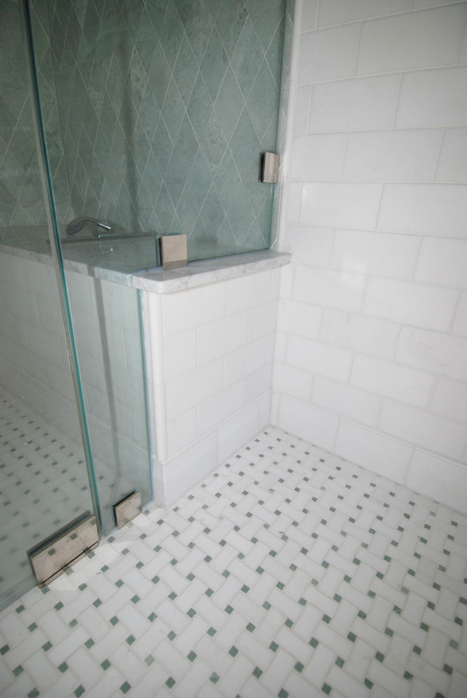 This is an example of a mid-sized traditional 3/4 bathroom in Milwaukee with a curbless shower, a one-piece toilet, multi-coloured tile, mosaic tile, green walls, marble floors, a console sink and marble benchtops.