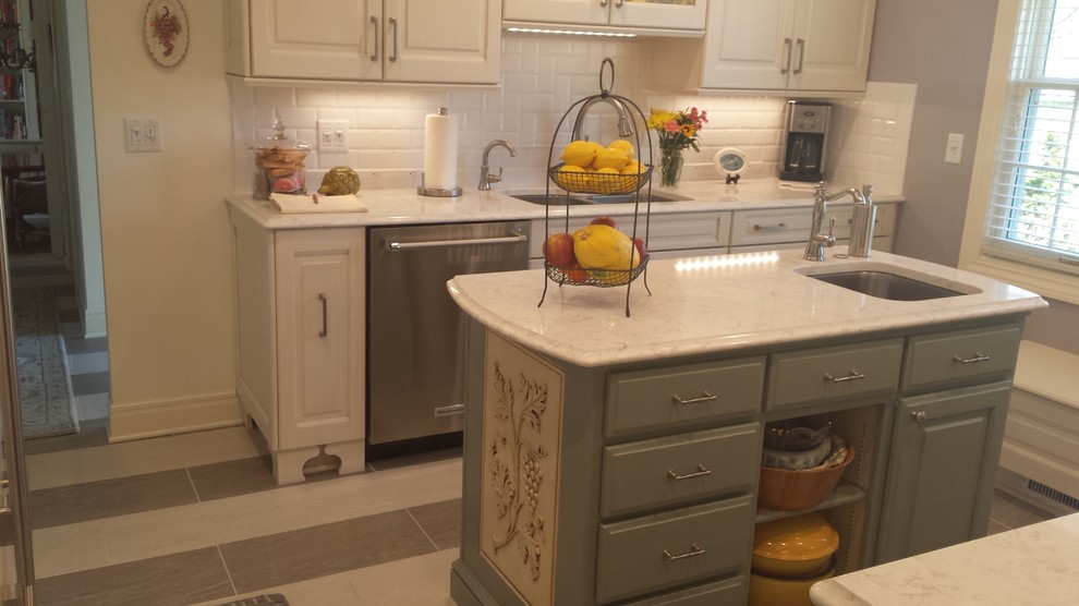 Inspiration for a small transitional u-shaped ceramic tile eat-in kitchen remodel with an undermount sink, raised-panel cabinets, white cabinets, marble countertops, white backsplash, subway tile backsplash, stainless steel appliances and an island