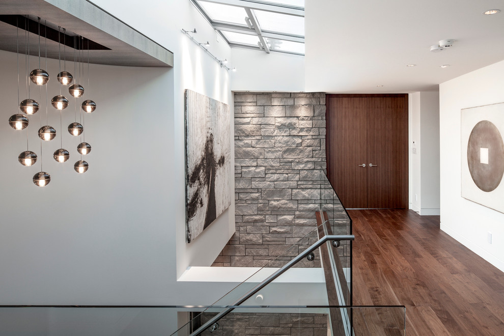 Photo of a contemporary hallway in Vancouver with white walls and dark hardwood floors.