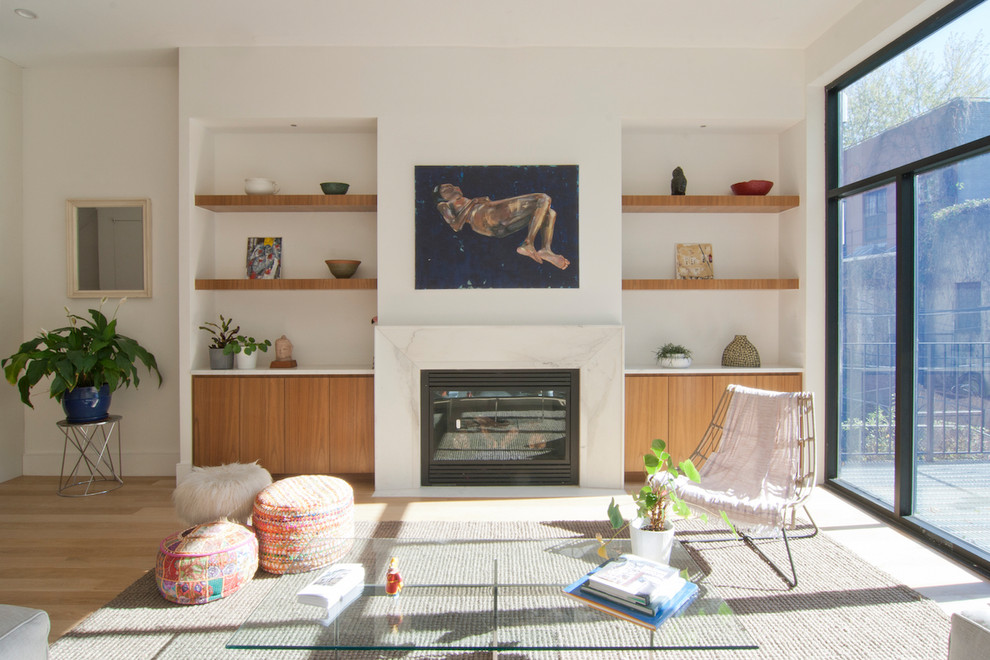 Example of a mid-sized trendy formal and open concept light wood floor and white floor living room design in New York with beige walls, a standard fireplace, a stone fireplace and no tv