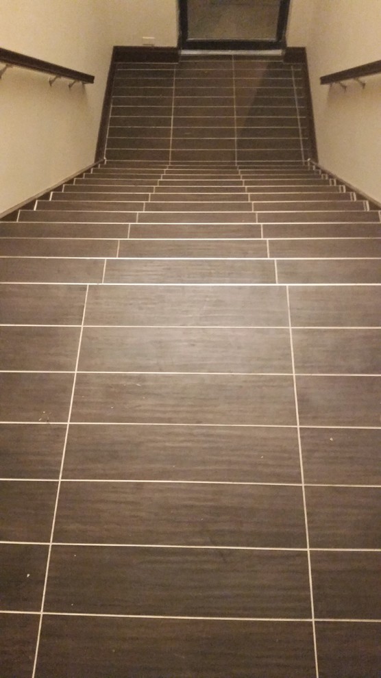 Design ideas for a mid-sized contemporary tile staircase in Chicago with tile risers.